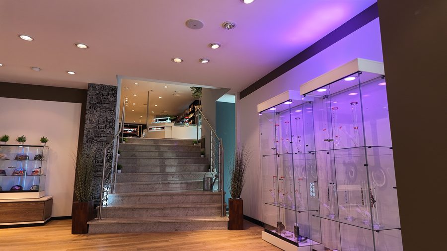Treppe und beleuchtete Glasvitrinen im Orange Spot Hof